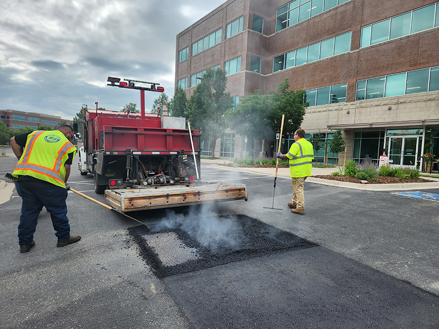 2 BBA workers performing infrared asphalt repair